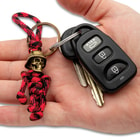 Full image of the Keychain hooked on a set of keys held in hand.